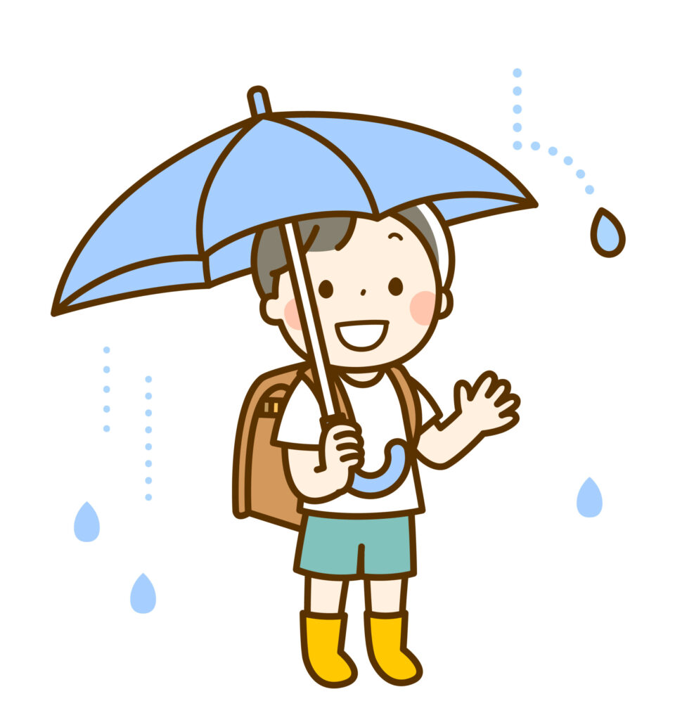 傘をさす小学生の男の子